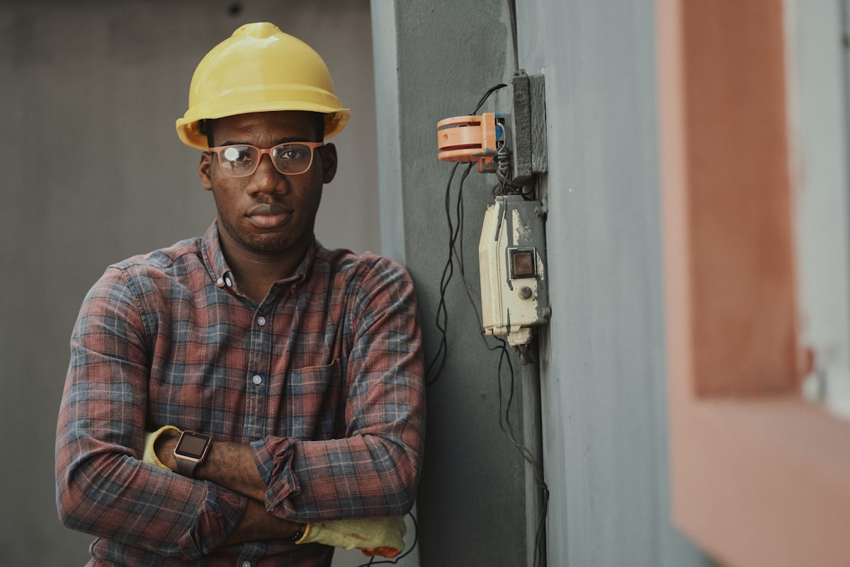 Electrician standing beside an electrical installation